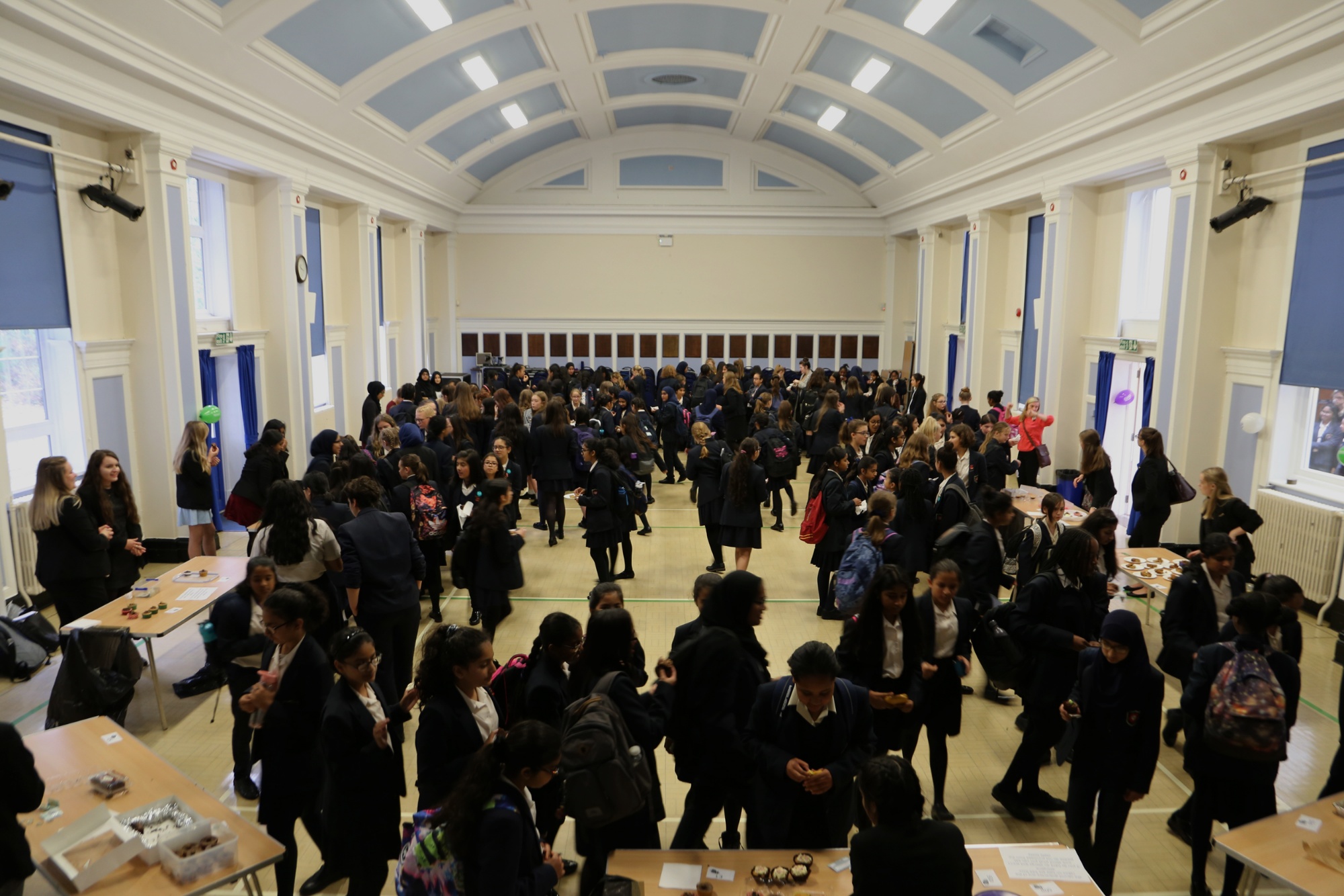 students gather to buy cake for charity